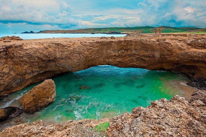 a rocky beach next to the water