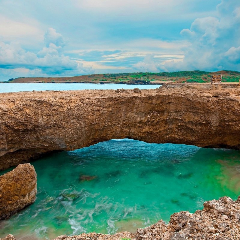 a rocky beach next to a body of water
